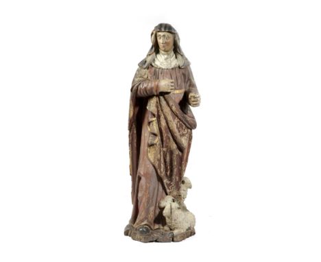 A CARVED OAK AND POLYCHROME FIGURE OF ST. AGNES OF ARRAS FRENCH, 17TH / 18TH CENTURY the robed saint accompanied by three lam