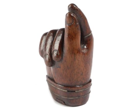 A TREEN 'PINCH OF SNUFF' SNUFF BOX SECOND HALF 19TH CENTURY carved in the form of a hand sporting a brass ring, the base with