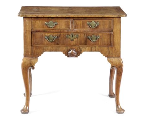 A GEORGE II WALNUT LOWBOY C.1725-30 the quarter veneered top with cross and feather banding, with a caddy moulded edge with r