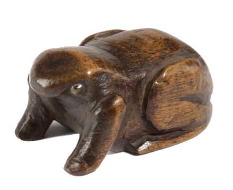 A TREEN FROG SNUFF BOX MID-19TH CENTURY with glass eyes, the underside with a sliding cover 7cm long