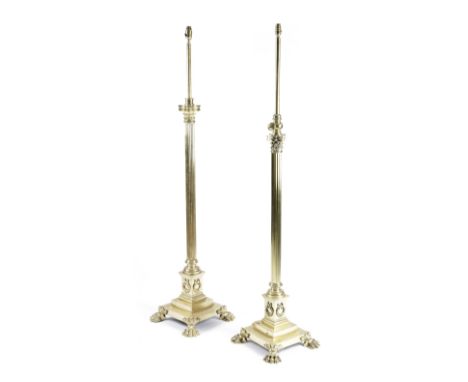 TWO BRASS CORINTHIAN COLUMN STANDARD LAMPS LATE 19TH CENTURY each with an adjustable light fitting, above a ribbed stem and a