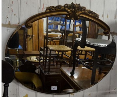 A vintage gilt framed and bevelled edged wall mirror.