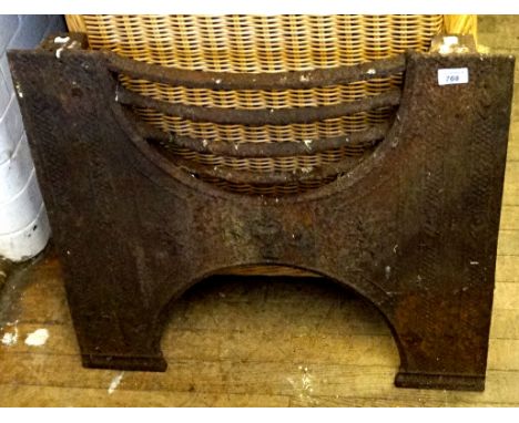A vintage cast iron fire grate.