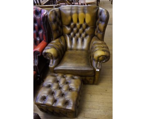 A Vintage brown leather Chesterfield armchair and matching stool.