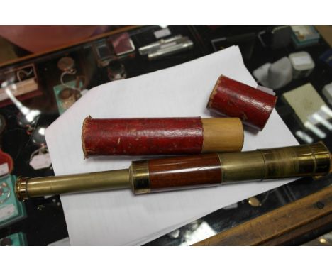 A pocket telescope inscribed 'K Henderson' in a faux leather case