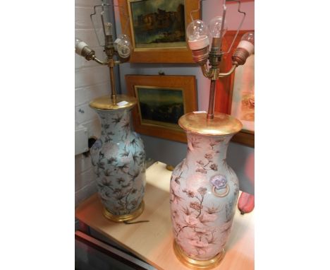 A pair of Chinese hand-painted vases decorated with white flowers on a light blue ground, converted to lamps