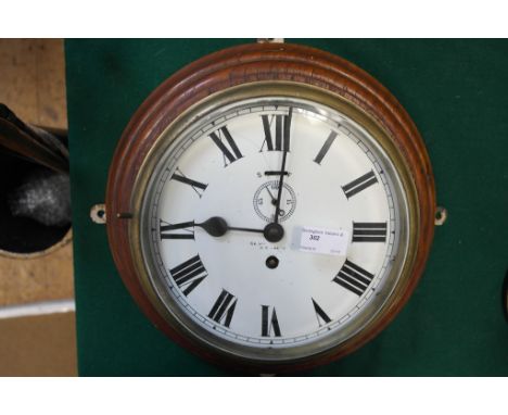 A ship's clock with mahogany surround