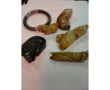 Four Oriental carved animals; together with a bangle