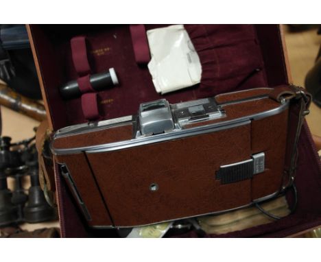 A vintage cased Polaroid Land Camera with Flash and accessories