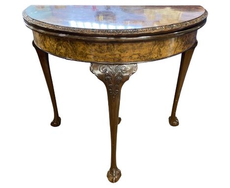 Reproduction walnut veneered demi lune card table with green baize lined interior raised on tapering legs with ball and claw 