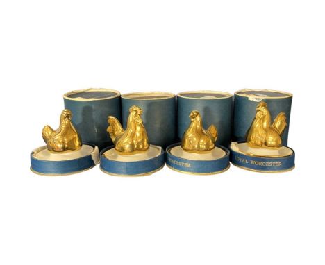 Set of four Royal Worcester egg cup holders, the tops modelled in gilt as chickens, the four all in original boxes