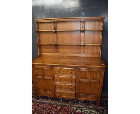 Ercol elm dresser with shelved back over a base with two panelled doors and four drawers, 146cm wide