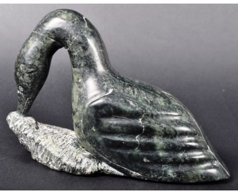 Melia Padluq - A large Inuit art hand carved polished shiny black stone figurine depicting a loon / bird. The figure with car