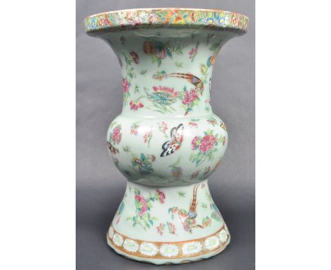 A 19th Century Chinese Oriental Qing Dynasty hand painted ceramic vase having a flared and gilt painted rim with floral detai