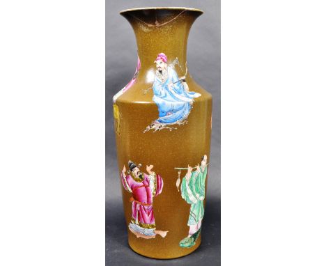 A 19th Century Chinese Oriental Qing Dynasty hand decorated ceramic vase having a flared rim and waisted neck over a tapering