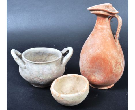 A collection of three Ancient pottery pieces comprising a Vallanovan Skyphos twin handled bowl circa 7th Century BC, Roman Te