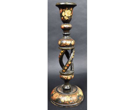 A 19th Century Persian Kashmir wooden single candlestick having a shaped bell candle sconce with bluster section above an ope