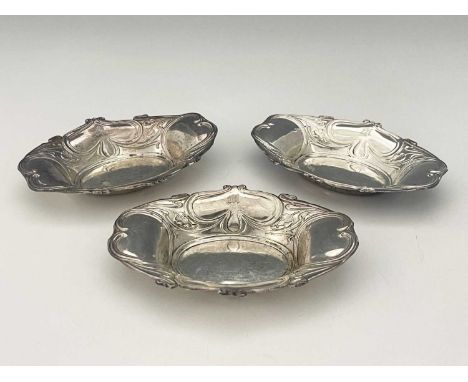 A set of three George V silver Art Nouveau bon bon dishes, each of shaped oval form, decorated with organic foliate tendrils,