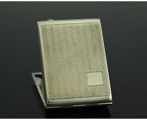 A George V Art Deco silver matchbook holder, of rectangular form, the exterior decorated with engine-turning, the hinged cove