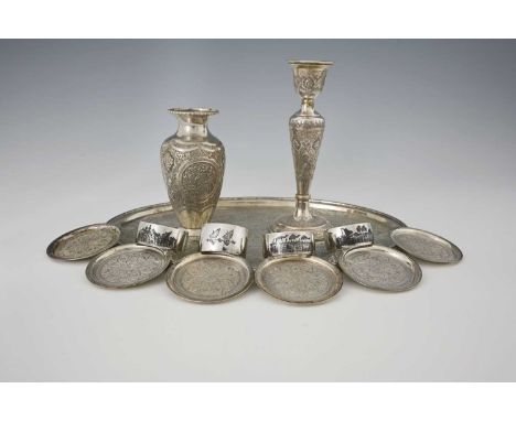 A group of twentieth-century Persian silver-coloured metal items, to include four niello decorated napkin rings, an oval salv