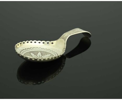 A George III silver tea caddy spoon, the rounded bowl decorated with bright-cutting, wriggle work, and central flowerhead, wi