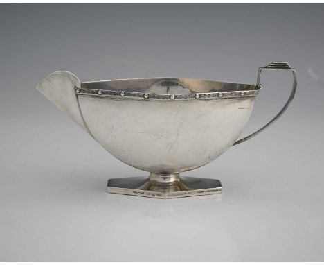 A George VI Art Deco style silver sauce boat, of navette form, the rim with Celtic-style decoration, atop a hexagonal form fo