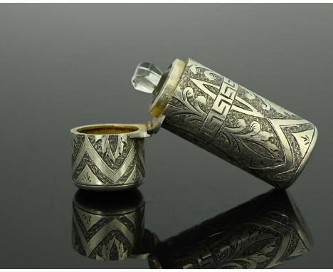 A Victorian silver perfume flask, of cylindrical form, the exterior decorated with foliate scrolls and central band of Greek 
