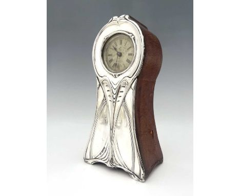 An Edwardian silver-mounted Art Nouveau desk or mantle timepiece, the balloon-shaped leather covered case, with an applied si