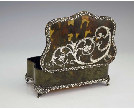 An Edwardian silver-mounted tortoiseshell dressing table or jewellery box, of shaped rectangular form, with cast mounts forme