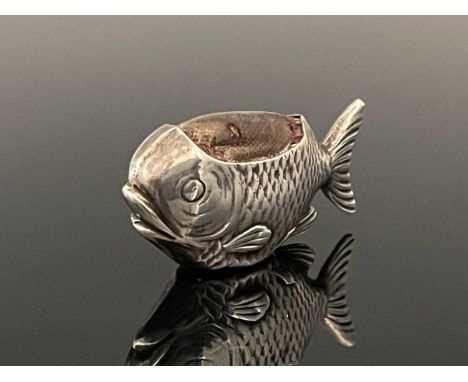 An Edwardian silver novelty pin cushion, modelled in the form of a fish, the body decorated to simulate scales, with cushion 