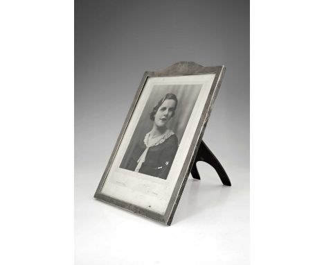A Scottish George V silver photograph frame, of rectangular form with domed top, the exterior decorated with engine-turning, 