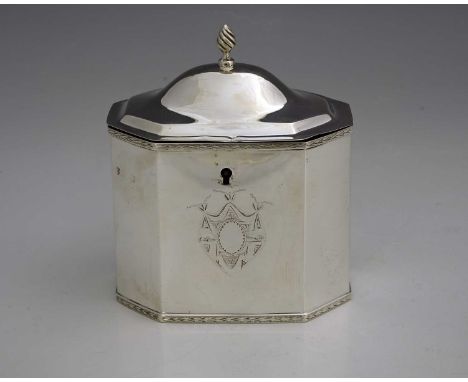 An Edwardian silver tea caddy, of octagonal form, the hinged domed cover with wrythen form finial, opening to reveal a gilt i