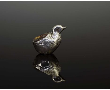 An Edwardian silver novelty pin cushion, modelled in the form of a hatching duckling, the body decorated to simulate feathers