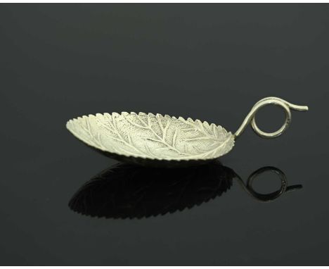 A George III silver novelty tea caddy spoon, modelled in the form of a leaf, the handle formed as a coiled foliate tendril, J