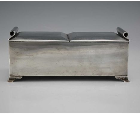 A George V silver cigarette box, of rectangular form, with dual hinged covers, each with turned scroll handles, the body with