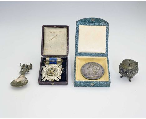 An Edwardian silver caddy spoon, with cast figural finial, depicting Adam, Eve, the apple and serpent, Continental in origin,