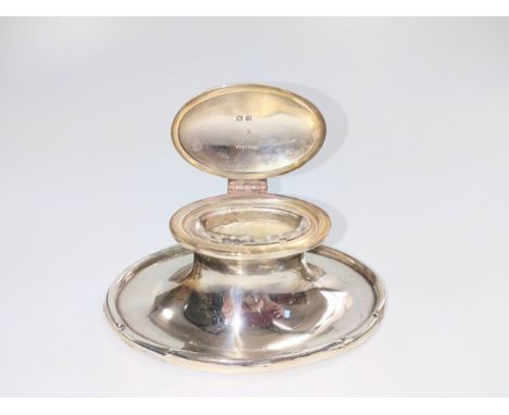 An oval silver inkwell with liner. F 
