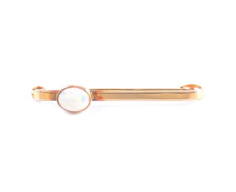 An oval cabochon cut opal collet set on a 15 carat gold 45mm tie bar/brooch, Chester 1927, 2.8g, vintage brooch box, W Bedfor