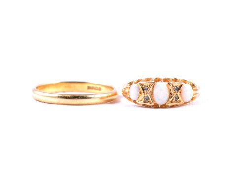 An opal and diamond chip ring, and a gold wedding band, an opal and diamond chip ring, the three cabochon cut opals divided b