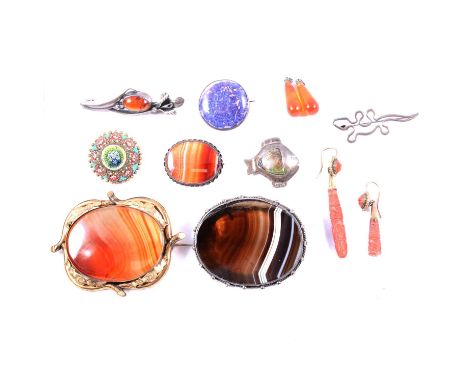 Two large banded agate brooches, one in a pinchbeck mount 65mm, the other silver coloured 5mm; a smaller banded agate brooch,