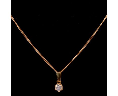 A solitaire diamond pendant and chain, the brilliant cut stone six claw set in an 18 carat yellow gold mount on an 18 carat y