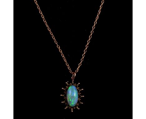 An Edwardian opal pendant on a yellow metal chain, an oval cabochon cut opal, approximately 16x9mm, claw set to the centre of