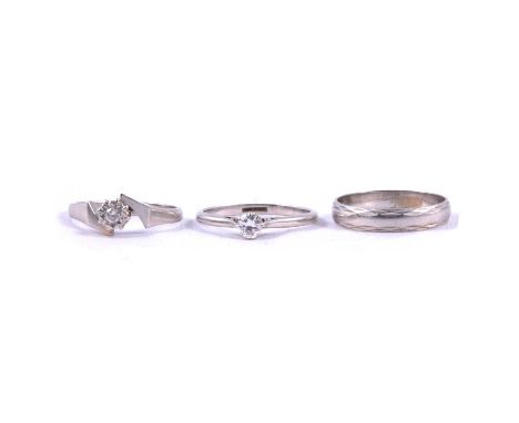 A diamond solitaire ring, illusion set ring and wedding band, all platinum, a diamond solitaire ring, the 4.2mm diameter bril