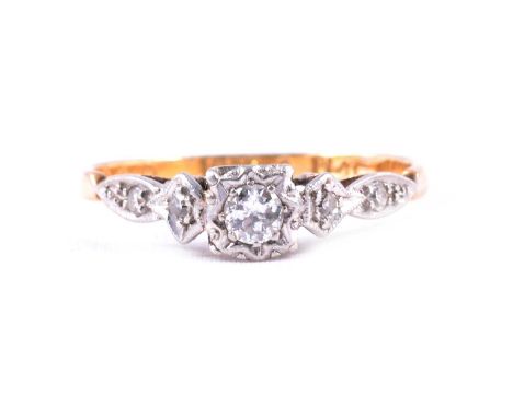 A diamond solitaire ring, the central brilliant cut stone with two 8 cut stones to either side all claw and illusion set in a