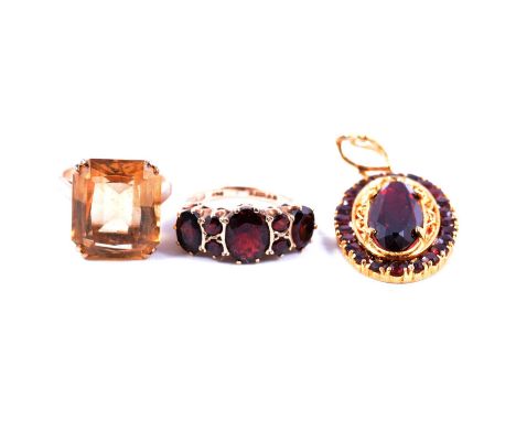 A synthetic ruby and garnet pendant, a garnet ring and a citrine ring, a synthetic ruby and garnet pendant, the oval mixed cu