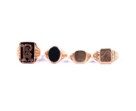 Four gold and yellow metal signet rings, an oval bloodstone yellow metal signet ring size P; a black onyx signet ring with ap