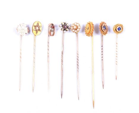 Seven various stick/tie pins, some with boxes, an 8.6mm seed pearl cluster; oval gold coloured pin marked 15c set with an unt
