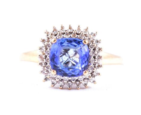 A tanzanite and diamond cluster ring, the 7.5mm faceted cushion shaped tanzanite claw set and surrounded by two rows of 8 cut