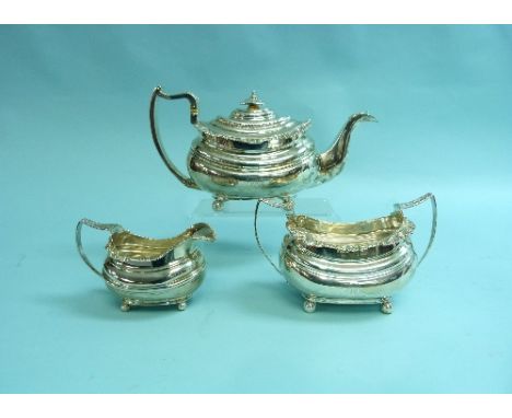 A George III silver three-piece Tea Set, by William Bateman, hallmarked London, 1819 and 1820, of ovoid form with leaf-capped