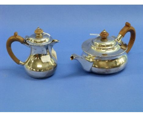 A Edwardian silver two piece Tea Set, hallmarked London, 1908, of squat circular form with wooden handles and finials, compri